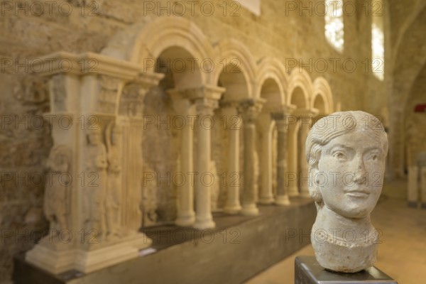 Stone female head in the museum at Gellone Abbey, also Saint-Guilhem-le-Désert Monastery, Département Hérault, France, Europe