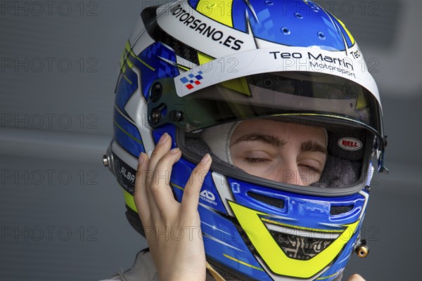 10 May 2024, Hockenheimring Germany : Spanish racing driver Alba Vazquez puts on her helmet and gets ready to get into the cockpit (GT Open)