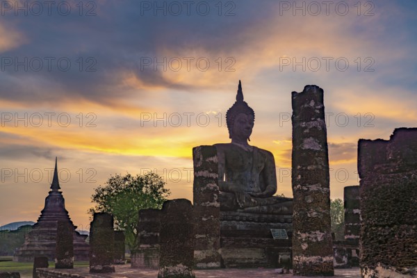 Sunset at a Buddha statue of the temple Wat Mahathat, UNESCO World Heritage Sukhothai Historical Park, Thailand, Asia