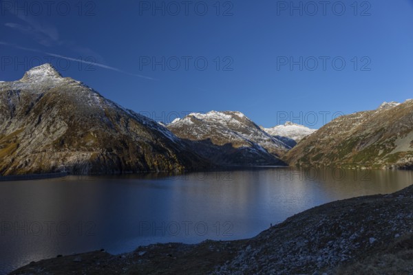 Kölnbrein reservoir and the Oberlecherspitzen mountain on a bright sunny morning. Seen from the Malta Hochalm road. Carithia, Austria, Europe