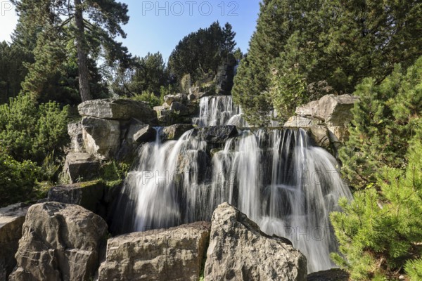 Essen, North Rhine-Westphalia, Germany - Alpinum with waterfall, Grugapark, a park in Essen, emerged from the first Great Ruhrland Horticultural Exhibition in 1929, was the park grounds of the 1965 Federal Garden Show