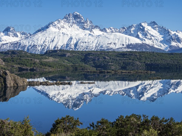 The snow-covered Mt. Cerro Castillo is reflected in a lake, Patagonia, Chile, South America