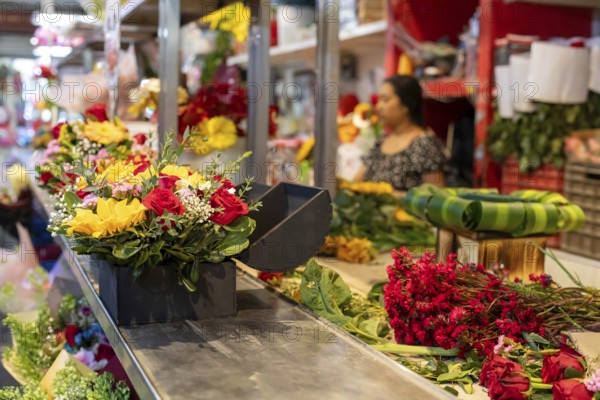 Oaxaca, Mexico, Flowers being sold on Valentine's Day at the Benito Juarez Market. Opened in 1894, it is one of the largest and oldest markets in Oaxaca. Its many dozen stalls sell food of every kind, clothing, souvenirs, and more, Central America