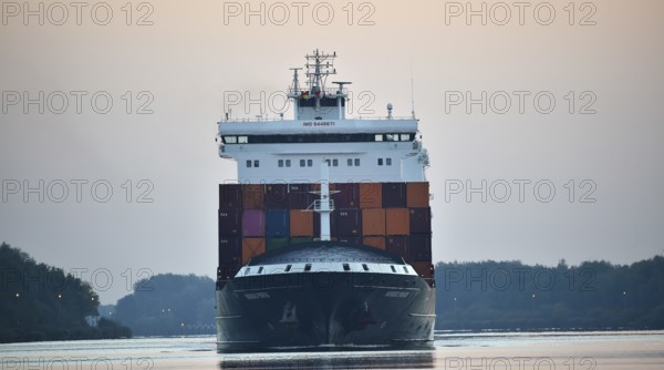 Container ship Nordic Porto sailing at sunrise in the Kiel Canal, Kiel Canal, Schleswig-Holstein, Germany, Europe