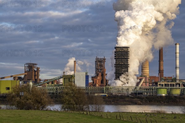 Industrial backdrop of the ThyssenKrupp Steel steelworks in Duisburg-Bruckhausen, on the Rhine, blast furnaces, Schwelgern coking plant, extinguishing cloud, Duisburg, North Rhine-Westphalia, Germany, Europe
