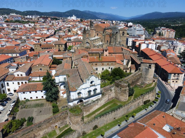 Historic buildings with red tiled roofs and castle walls in a town on a sunny day, aerial view, Plasencia, Cáceres, Caceres, Extremadura, Spain, Europe