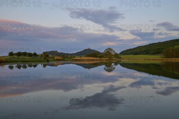 Lake with reflection in spring with castle at sunset, Veste Wachsenburg, Amt Wachsenburg, Drei Gleichen, Ilm-Kreis, Thuringia, Germany, Europe