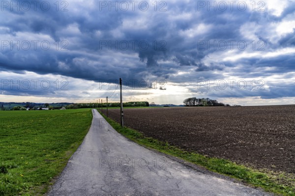 Field path, thick, black rain clouds, landscape in the Bergisches Land, near Halver, North Rhine-Westphalia, Germany, Europe