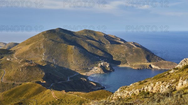 Sunny coastal road winding along a mountainous landscape overlooking the sea, southern tip, Mani Peninsula, Peloponnese, Greece, Europe