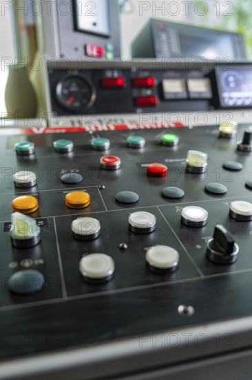 Close-up of a control panel with various round buttons and switches, Hermann Hesse railway track construction, Calw district, Black Forest, Germany, Europe