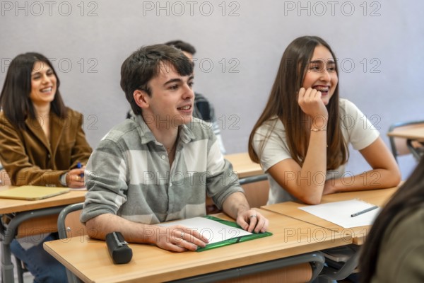 Group of happy and smiling students listening to their teacher in a classroom at their university or institute