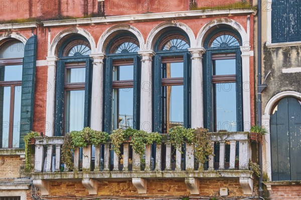 Windows of an old house on 'Campo santa margherita' town square in Venice on a sunny day in winter, Italy, Europe