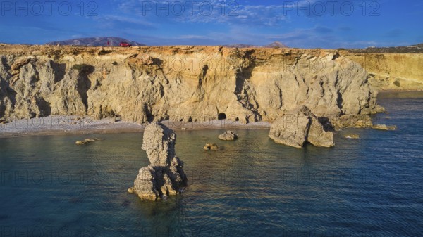 Impressive coastal landscape with imposing rock formations under a clear sky, drone shot, evening light, Araki Beach, southwest coast, Karpathos, Dodecanese, Greek Islands, Greece, Europe
