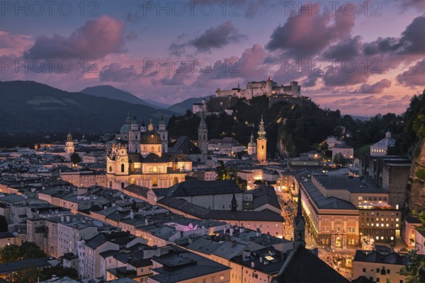 Salzburg's illuminated night view with the fortress and Alpine panorama, captured in the soft glow of lights, Salzburg, Salzburger Land, Austria, Europe