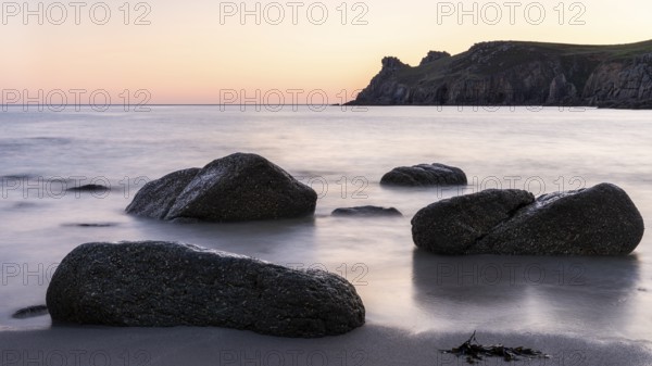 Coastal landscape. Rocks in the sea. In the evening after sunset. Long exposure. Nanjizal Bay, St Just, Penzance, Cornwall, England, Great Britain