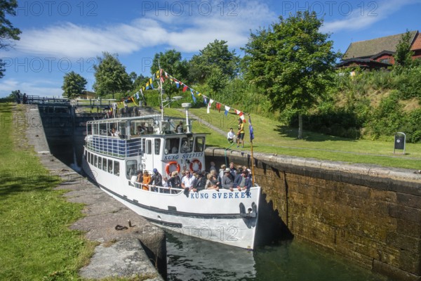 The excursion ship Kung Sverker in a lock on Göta Canal at Borenshult. Göta Canal was built between 1810 and 1832 and runs right through Sweden. Together with the Trollhätte Canal and the Göta River, the Göta Canal forms a 390-kilometer-long waterway from the Baltic Sea to the Kattegat. Motala, Östergötland, Sweden, Scandinavia, Europe