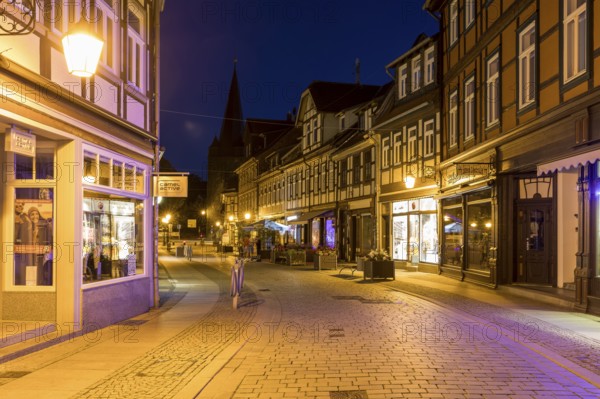 Half-timbered houses in the Westernstraße, in the background the Westerntorturm, shopping street at night, Wernigerode, Harz, Saxony-Anhalt, Germany, Europe