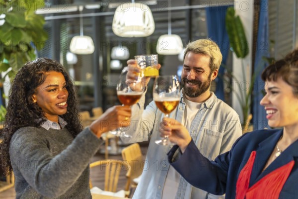 Multi-ethnic friends raising glasses and toasting celebrating success at night party in a bar terrace
