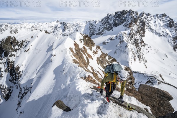Mountaineers climbing to the summit of Piz Grialetsch in winter, view of mountain panorama with Piz Vadret with snow, Grisons Haute Route, Albula Alps, Rhaetian Alps, Grisons, Switzerland, Europe