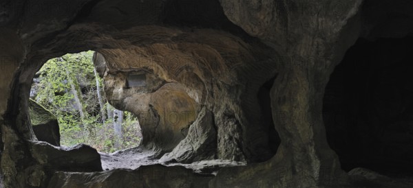 The Hohllay cave showing grooves and circles in the sandstone rock from carving millstones, Berdorf, Little Switzerland, Mullerthal, Grand Duchy of Luxembourg