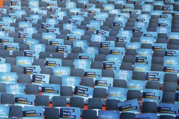 Assembly hall, deserted with many empty chairs and posters with the inscription UNSER KANNZLER. Bundestag election campaign of the CDU party for the party's candidate for chancellor Friedrich Merz, symbolic photo. Election rally in Künzelsau, Baden-Württemberg, Germany, Europe