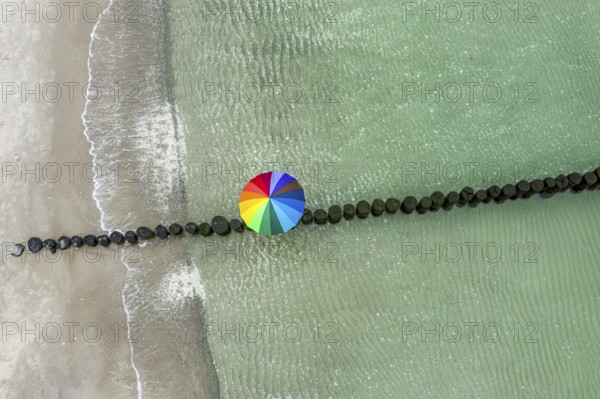 People with colorful umbrella on a groyne, beach of Baltic sea, aerial view, Mecklenburg-Western Pomerania, Germany, Europe