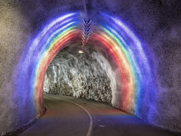 Colorful illuminated tunnel for bicycles and pedestrians leads up to Hardanger suspension bridge, Hardanger, Norway, Europe
