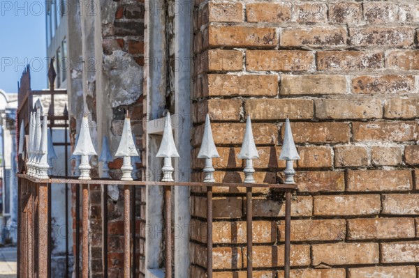 Arrowhead spikes on wrought iron fence at an above ground grave in St. Louis Cemetery No. 1 in New Orleans, Louisiana, USA, North America