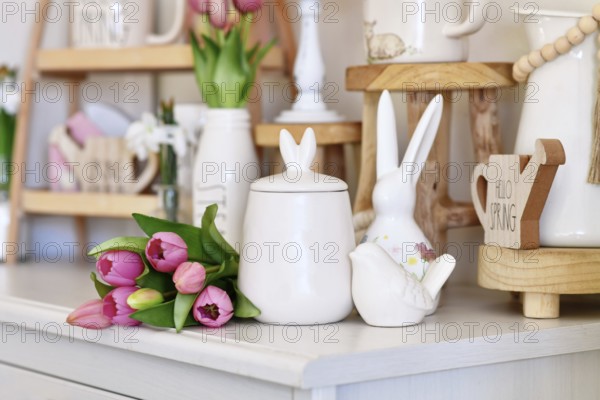Cute seasonal Easter decor with small canister with bunny ears, bird and pink tulip flower boquet
