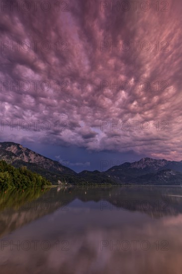 Stormy atmosphere, mountains reflected in lake, Lake Kochel, Alpine foothills, Bavaria, Germany, Europe