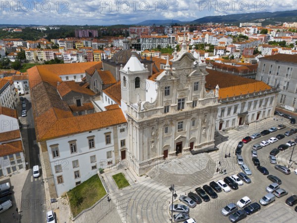 Historic baroque church in the city with a square in front of it and parked cars, aerial view, Cathedral, Coimbra, Rio Mondego, Portugal, Europe