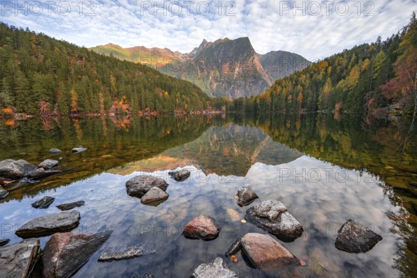 Mountain peaks of the Ötztal Alps reflected in Lake Piburger See, in autumn, near Ötz in Ötztal, Tyrol, Austria, Europe