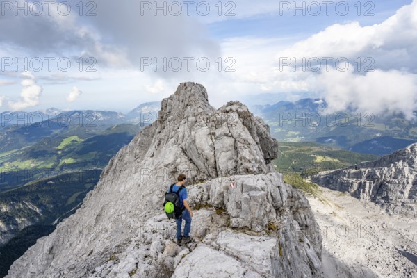 Mountaineer on a narrow rocky ridge, Watzmann crossing to Watzmann Mittelspitze, view of mountain panorama, Berchtesgaden National Park, Berchtesgaden Alps, Bavaria, Germany, Europe