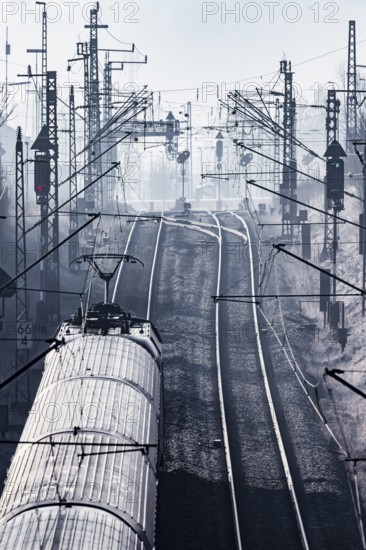Deutsche Bahn AG tracks against the light. Overhead line, signals and infrastructure. Railway tracks at the Geislinger Steige, Alb ascent to the Swabian Alb. Amstetten, Baden-Württemberg, Germany, Europe