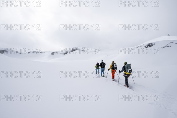 Group of ski tourers, Snowy mountain landscape, Bernese Alps, Bernese Oberland, Switzerland, Europe
