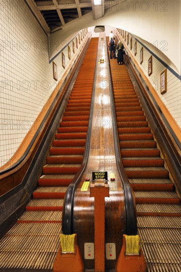 Passers-by on a wooden escalator in the Sint-Annatunnel, heritage-protected St Anne's Tunnel under the Scheldt, retro, Antwerp, Flanders, Belgium, Europe
