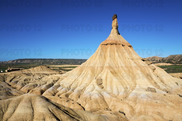 A striking rock formation in a desert landscape under a clear blue sky, Castildetierra, Bardenas Reales Natural Park, desert, semi-desert, Navarre, Nafarroa, UNESCO Biosphere Reserve, Spain, Europe