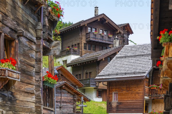 Old wooden houses with flower boxes in front of windows and balconies in the historic village centre, Grimentz, Val d'Anniviers, Valais Alps, Canton Valais, Switzerland, Europe
