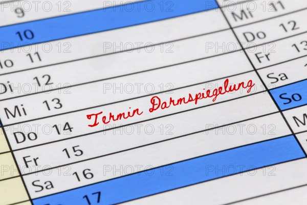 Symbolic image of colorectal cancer screening (early detection) : Calendar with note of an appointment for a colonoscopy