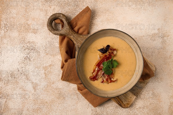 Pumpkin cream soup, curry, fried bacon, top view, no people