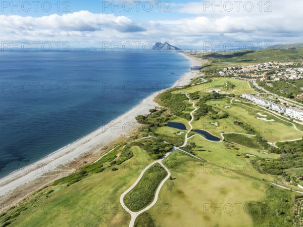 The La Hacienda Links Golf Resort at the Mediterranean Sea with the Rock of Gibraltar (British) in the distance. Aerial view. Drone shot. Cádiz province, Andalusia, Spain, Europe