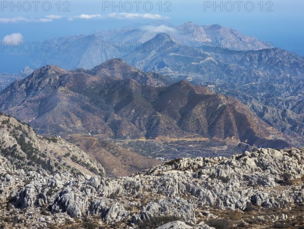 Deep view into the rough mountain and valley structure with blue and brown shades of northern Karpathos, hike to the summit of Kali Limni, Kali Limni, Lastos, Karpathos, Greece, Europe