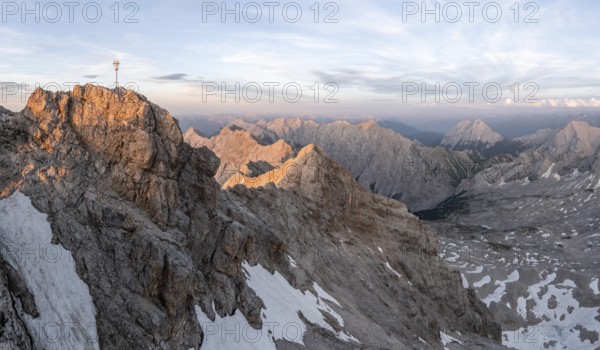 Summit of the Zugspitze with golden summit cross, alpenglow at sunset, Northern Limestone Alps, Wetterstein Mountains, Bavaria, Germany, Europe