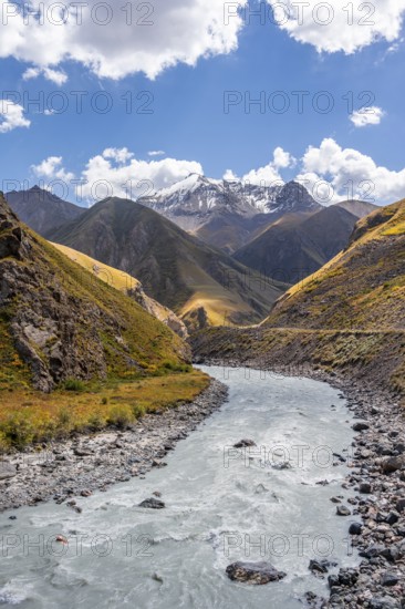 Mountain river in a valley, picturesque mountain landscape with white mountain peaks, Tian Shan Mountains, Issyk-Kul, Kyrgyzstan, Asia
