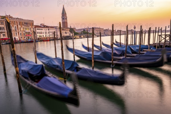 Venetian gondolas, boat dock at the customs office on the Grand Canal, Gondola Traghetto Dogana, Campanile behind, long exposure at sunrise, Venice, Veneto, Italy, Europe