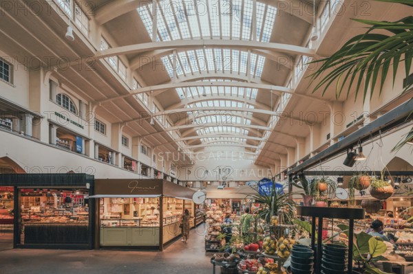 A bright, airy market hall with various stalls selling fresh fruit and vegetables under a high ceiling, Markthalle, Stuttgart, Baden-Würrtemberg, Germany, Europe