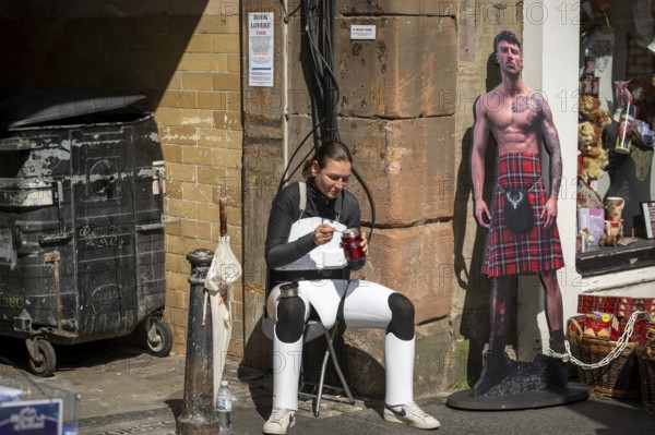 Participant taking a lunch break, world's largest cultural festival The Fringe, High Street, Edinburgh, Scotland, United Kingdom, Great Britain, Europe