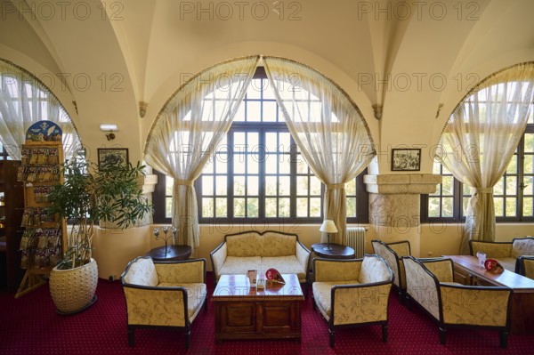 Cosy interior with large windows, curtains, seating areas and warm lighting, Elafos Hotel, Profitis Ilias, Rhodes, Dodecanese, Greek Islands, Greece, Europe