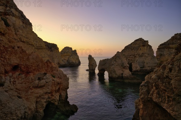 Coloured cliffs and sunrise, rocks in the sea, Ponta da Piedade, Lagos, caves, cliffs, Atlantic Ocean, Algarve, Portugal, Europe