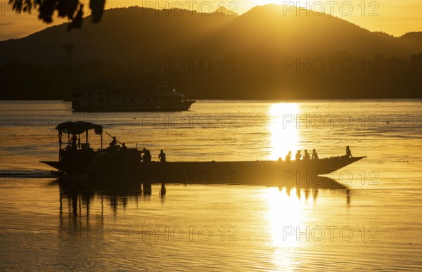 Boats in the Brahmaputra river, during sunset in Guwahati, Assam, India on 1 August 2023